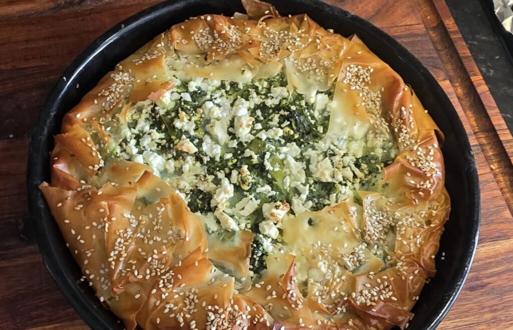 A whole spanakopita spinach and feta filo pie baked at Kalimera, Harpenden