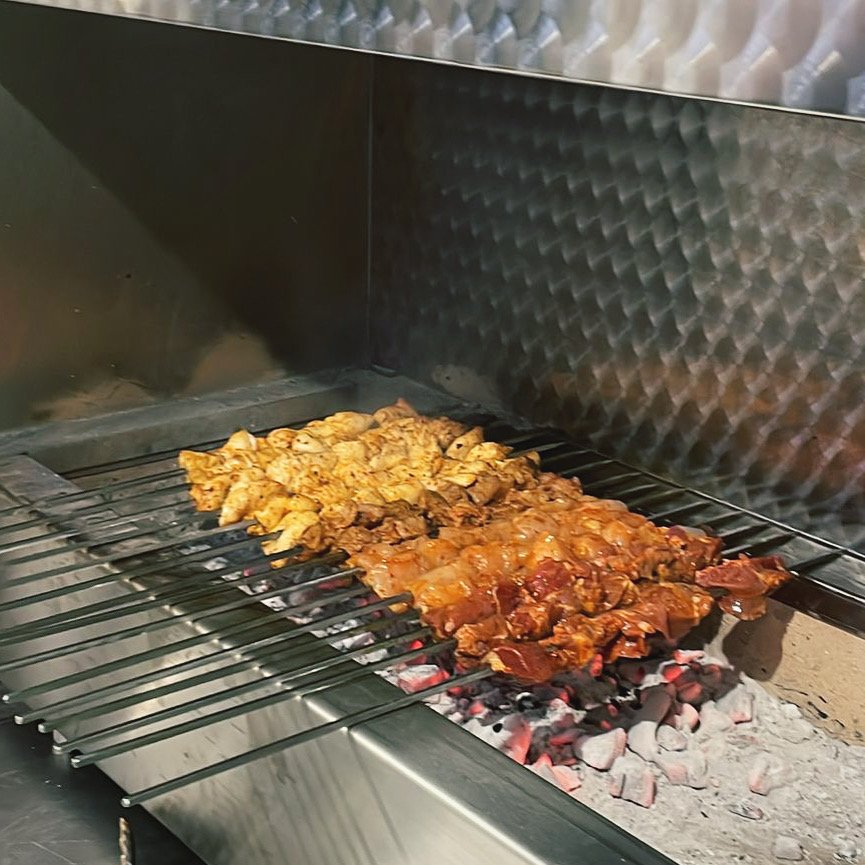 Kebabs cooking over charcoal at Town Grill Kebab, Southdown Road, Harpenden