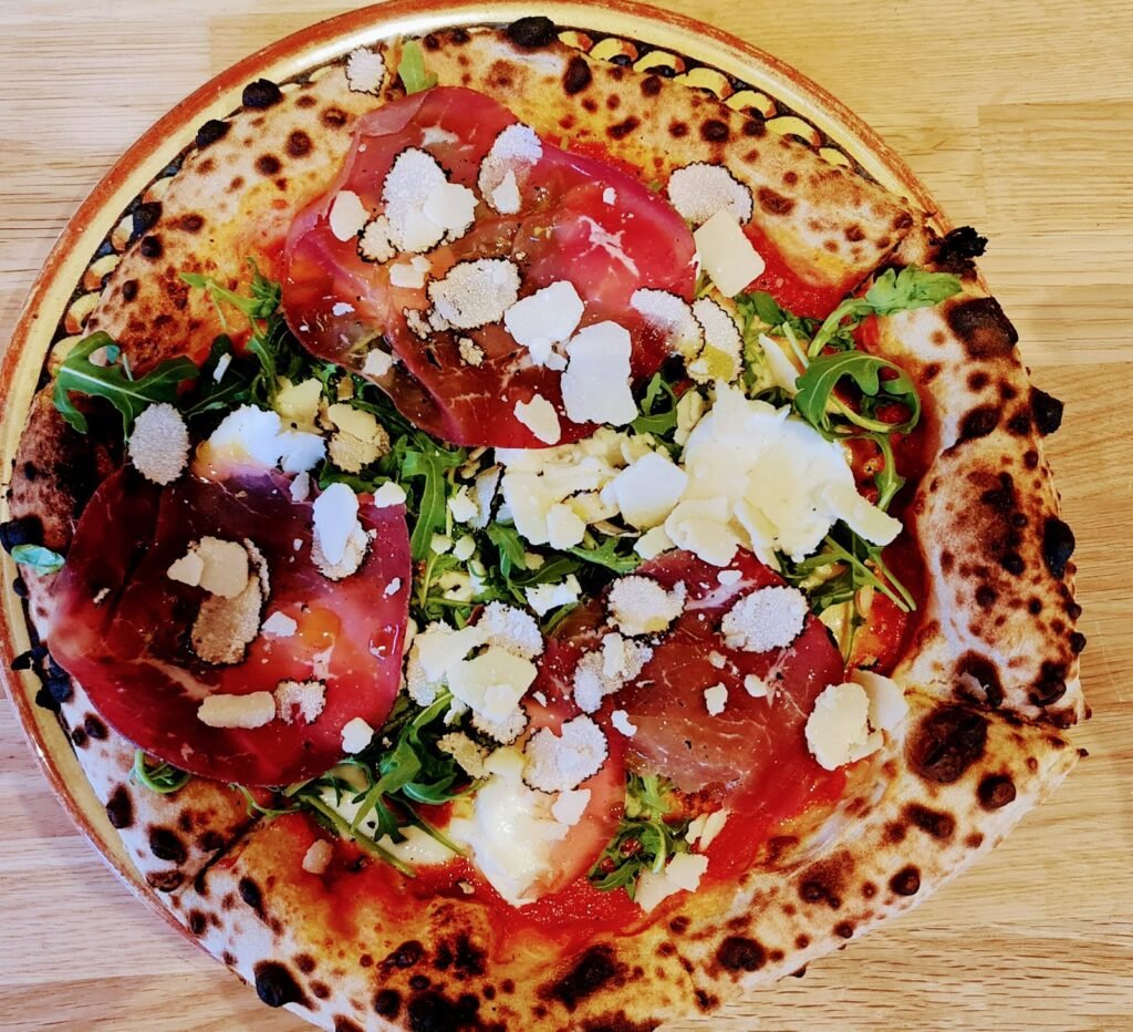 A pizza with rocket and shaved cheese from Zio's Pizzeria, Station Road, Harpenden